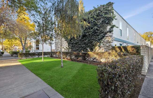 A building with a green lawn in front of it.