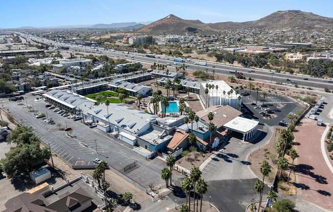 A large building complex with a parking lot in front of it at Presidio Palms Apartments, Tucson, 85701
