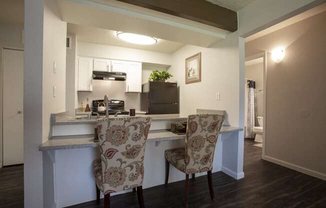 Dining area and kitchen at Tierra Pointe Apartments in Albuquerque NM October 2020