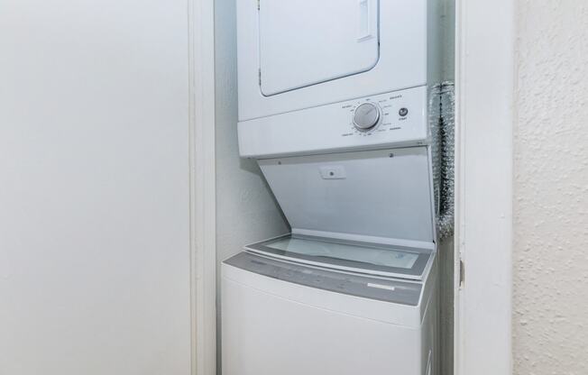 a washer and dryer in a small closet