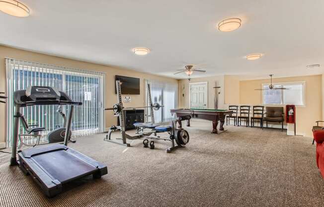 a gym with a ping pong table and a pool table