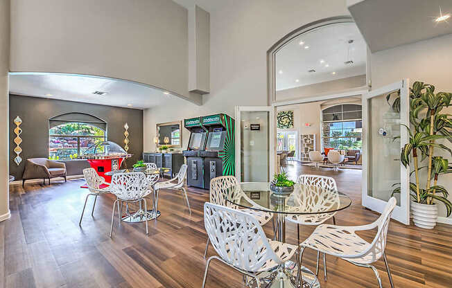 A modern dining room with a glass table and chairs.