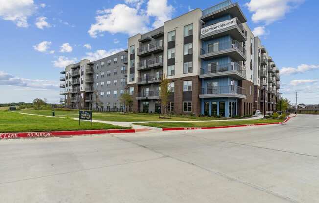 a large apartment building on the side of a road