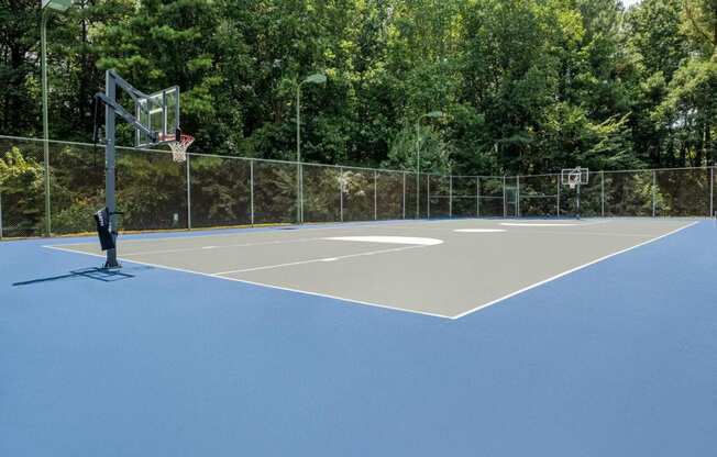 a tennis court with a basketball hoop on it