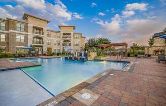 a large swimming pool with a building in the background