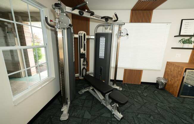 a home gym with exercise equipment and a window