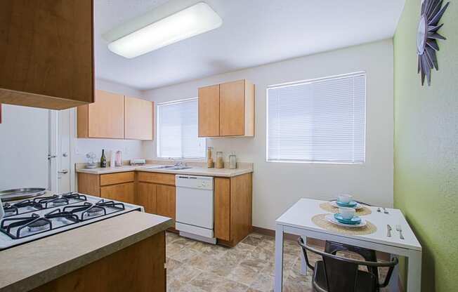 a kitchen with wooden cabinets and a white table