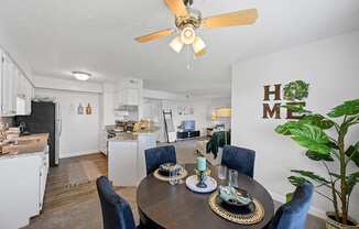 a living room with a dining table and a kitchen