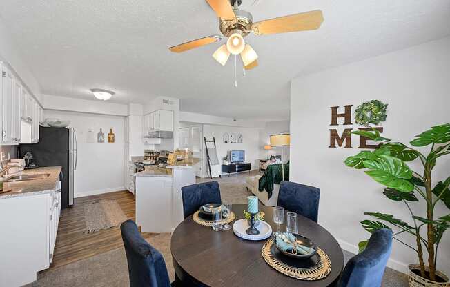 a living room with a dining table and a kitchen