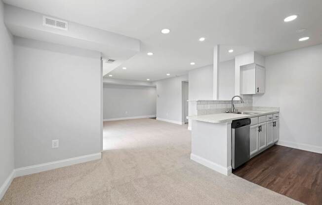 A spacious kitchen with white cabinets and a dishwasher.