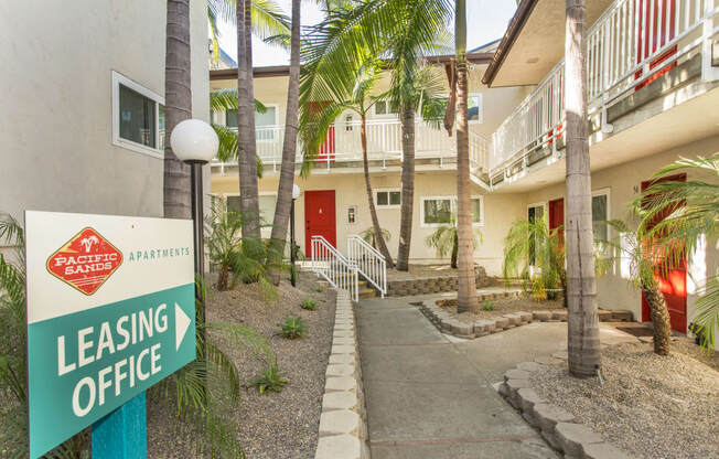 Pacific Sands walkway with Leasing Office sign and tropical landscaping at Pacific Sands, San Diego, CA, 92117