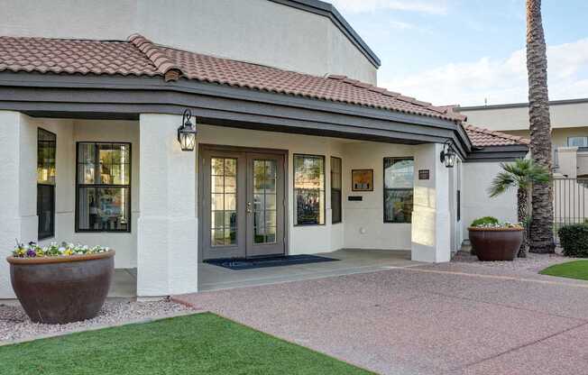 A building with a red tile roof and a glass door.