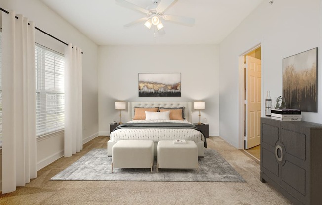 a bedroom with a bed and a ceiling fan at Stone Gate Apartments in NC