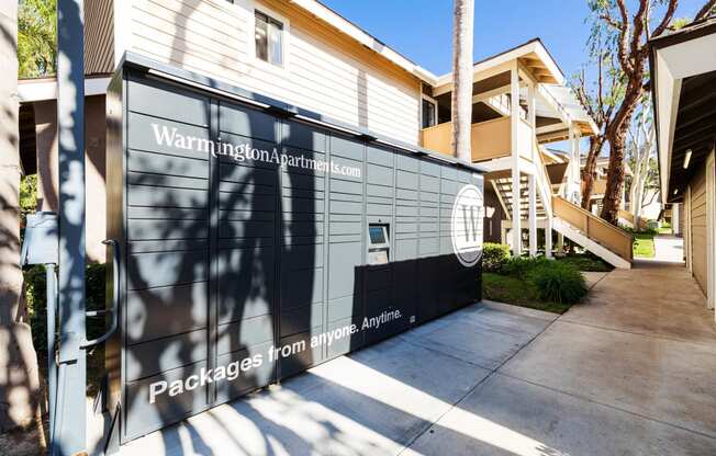 the side of a house with a driveway and a gate