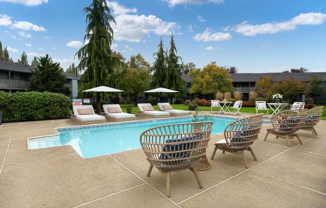 a swimming pool with chairs and umbrellas