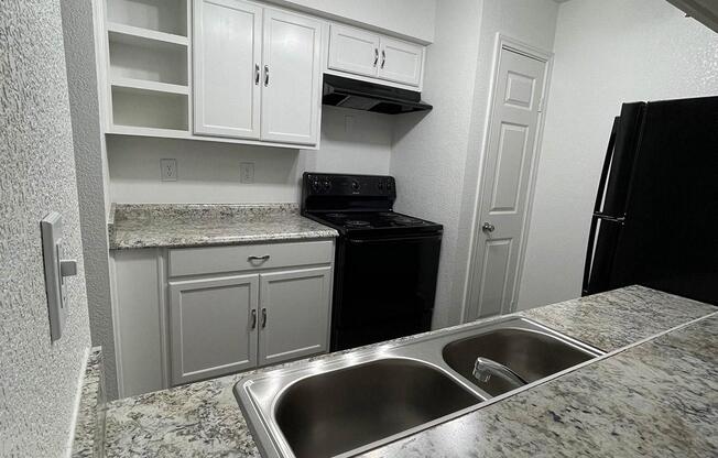 a kitchen with a stove and a sink