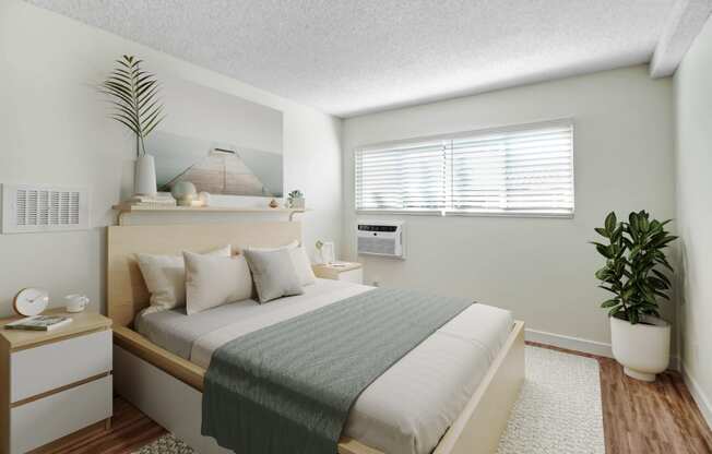 a bedroom with a large bed and a plant