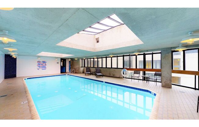 a large swimming pool with a skylight above it