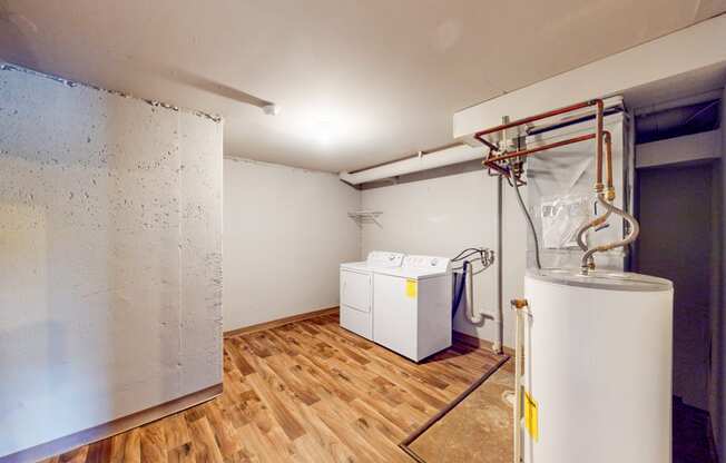 a laundry room with a washer and dryer and a refrigerator