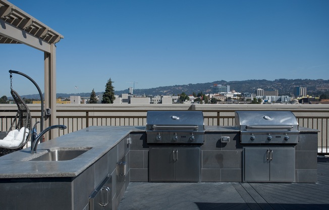 Oakland CA Apartments for Rent - Expansive Rooftop with a Great View of the City Featuring Various Shaded Lounging Areas and Outdoor Grill
