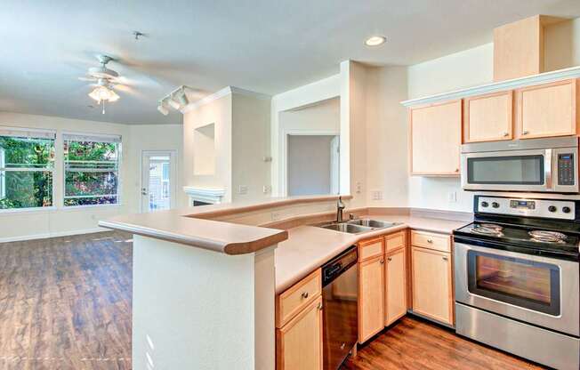 A kitchen with wooden cabinets and stainless steel appliances.