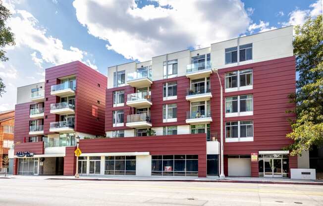 a red apartment building on the corner of a street