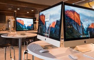 a room with two computer monitors on a table