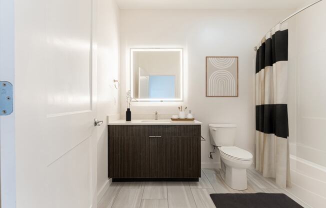 a bathroom with a sink toilet and shower at The Box, Richmond, 23224