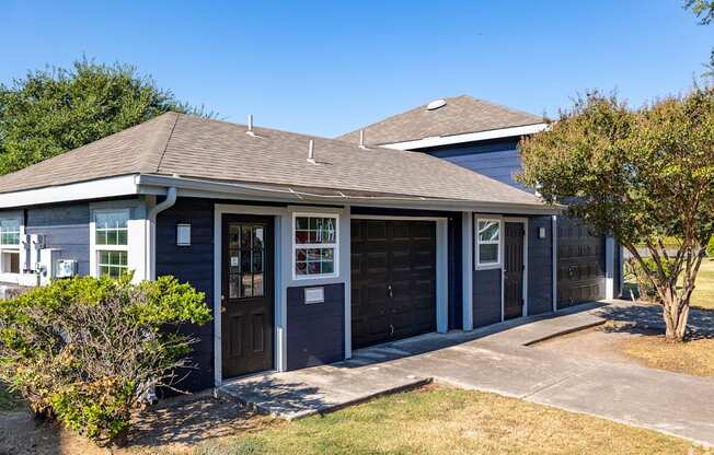 A house with a brown roof and a grey garage door.