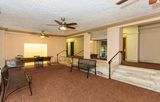 a living room filled with furniture and a ceiling fan