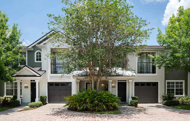 the exterior of a house with a tree in front of it