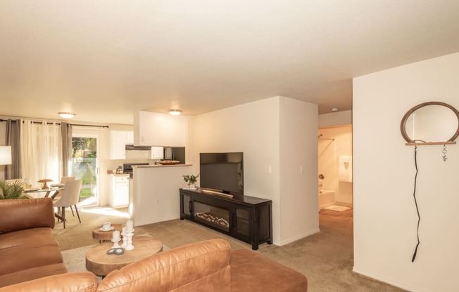 a living room with a leather couch and a television