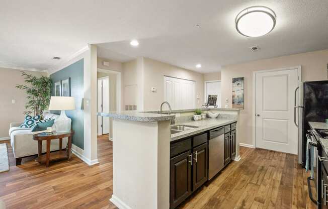 an open kitchen and living room with a large counter top