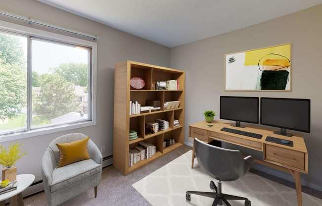 Comfortable and spacious living area styled for a work from home set up with a large window filling the room with natural light.