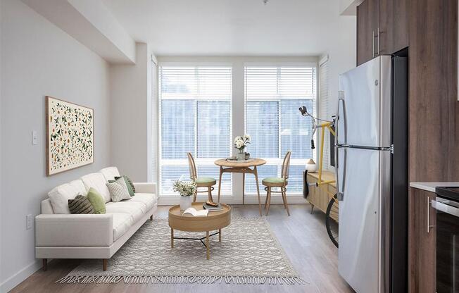 a living room with a couch and a table and a refrigerator