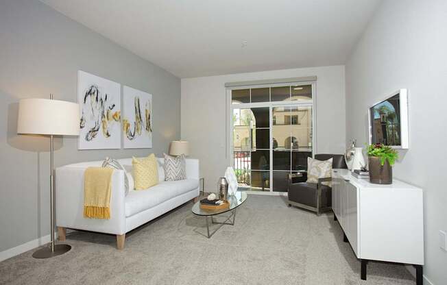 A living room with a white couch and a coffee table.