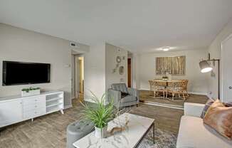 A living room with a grey couch and a white coffee table.