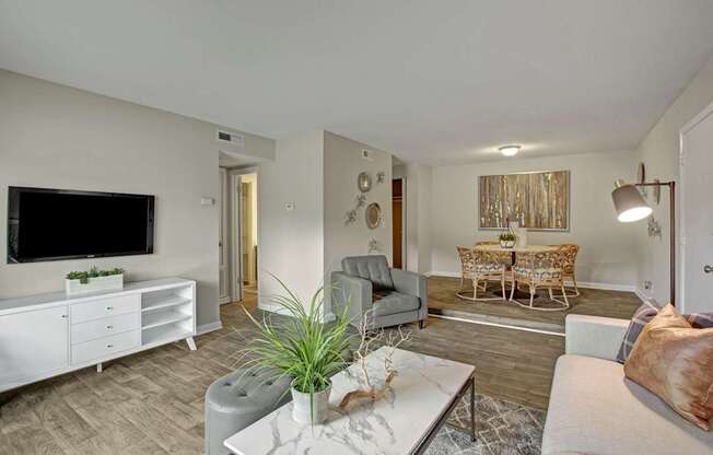 A living room with a grey couch and a white coffee table.
