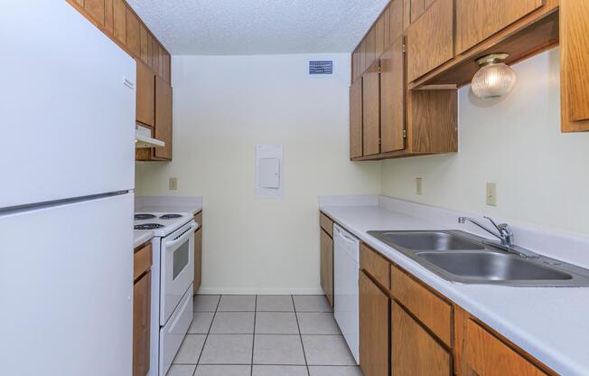 a kitchen with a stove sink and refrigerator