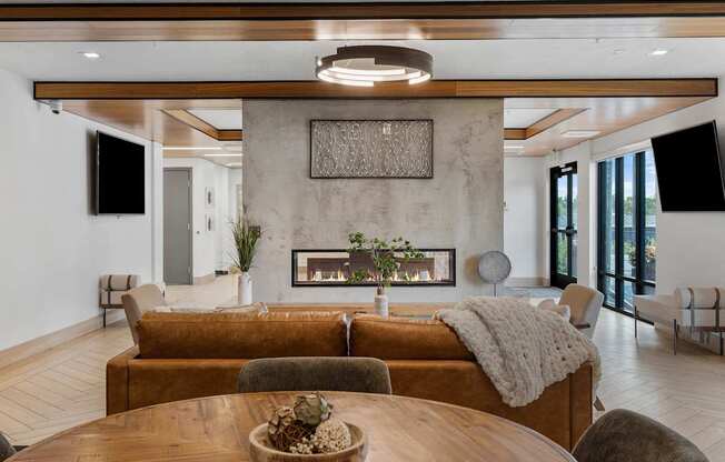 a living room with a couch and a table and a fireplace