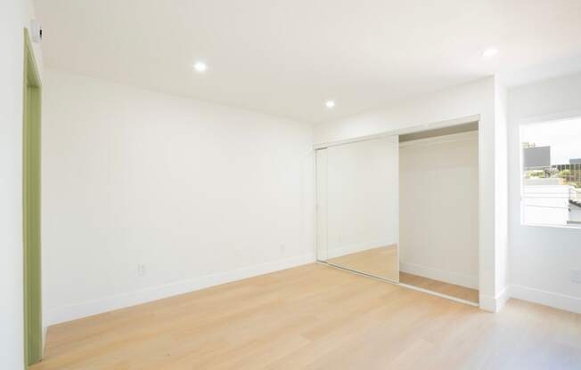 a living room with white walls and a sliding glass door