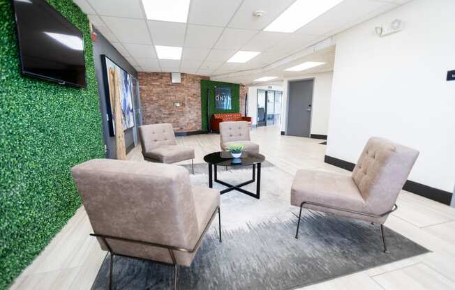 a waiting room with brown chairs and a green wall