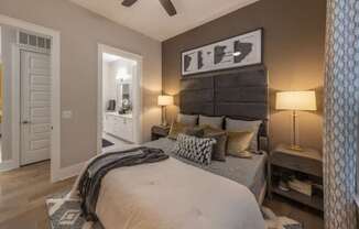 A bedroom with a large bed and a ceiling fan.