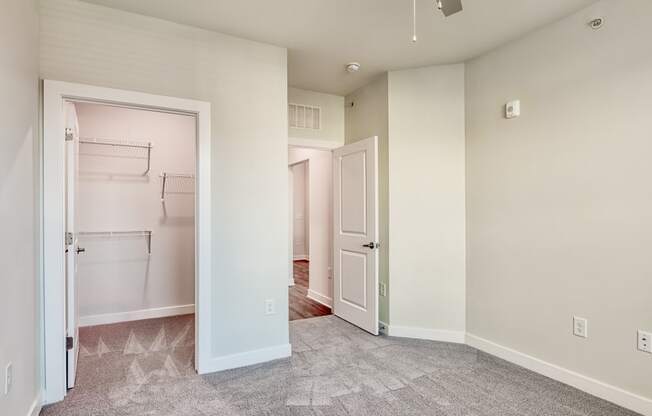 an empty room with a closet and a door to a laundry room at The Bella at Westchester, Midlothian, 23113