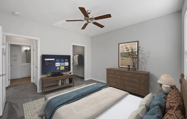 a bedroom with a large bed and a ceiling fan