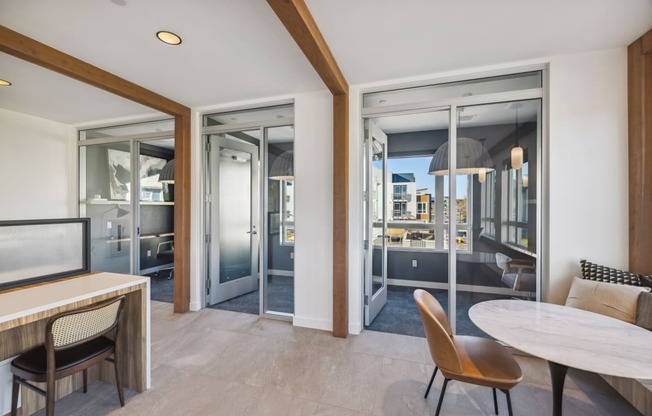 a living room and dining room with sliding glass doors and a view of the city