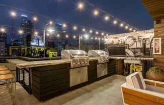 an outdoor kitchen with a city skyline in the background