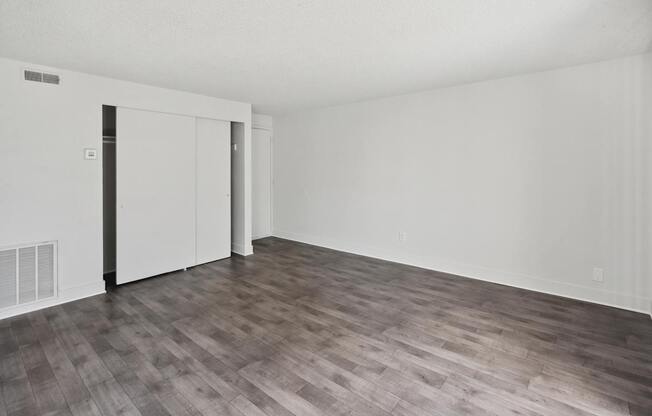 A room with a wooden floor and white walls.