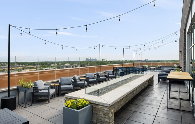 the rooftop terrace at the envoy hotel has seating and a view of the city