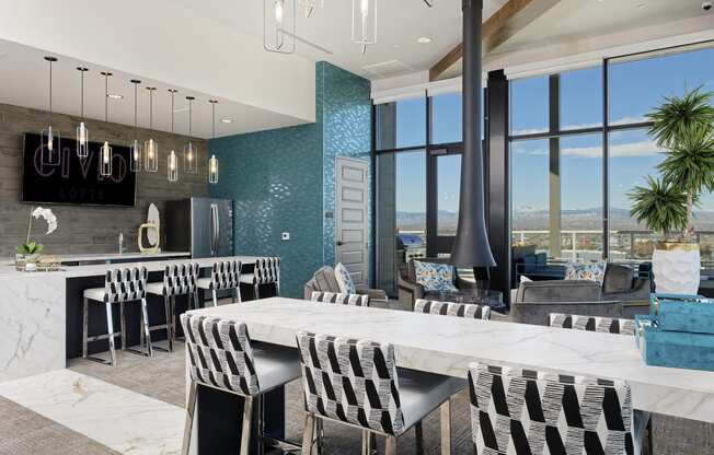 Sky lounge kitchen area, with full kitchen and bar, high seating, and fireplace connected to the ceiling